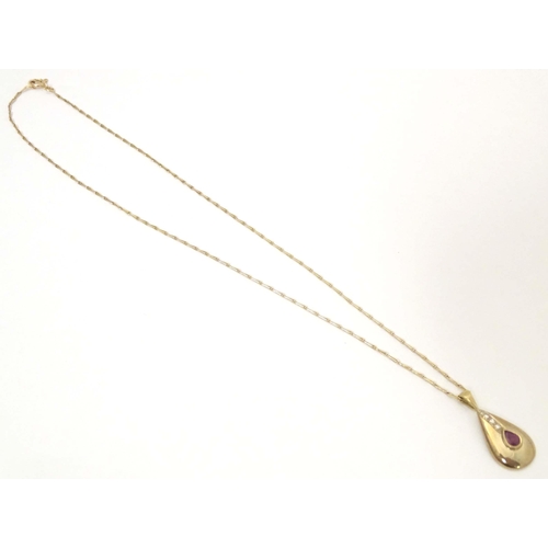 640 - A 9ct gold pendant and chain the pendant of drop form set with ruby and diamonds. Approx 1