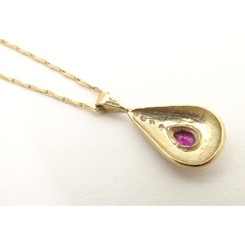 640 - A 9ct gold pendant and chain the pendant of drop form set with ruby and diamonds. Approx 1