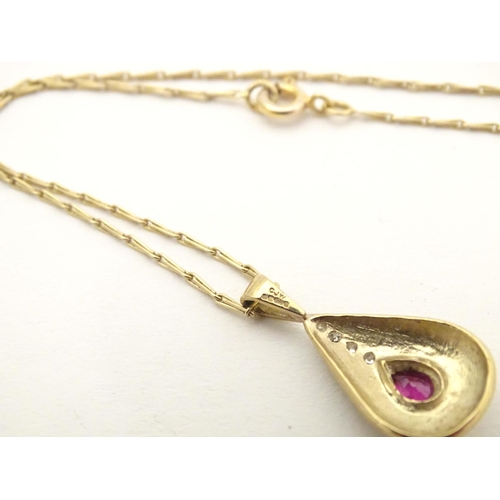 640 - A 9ct gold pendant and chain the pendant of drop form set with ruby and diamonds. Approx 1