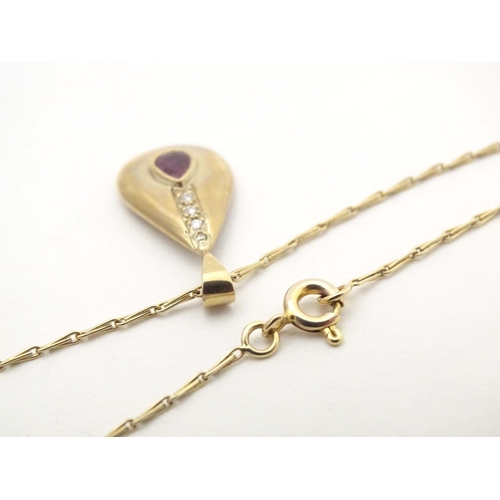 640 - A 9ct gold pendant and chain the pendant of drop form set with ruby and diamonds. Approx 1