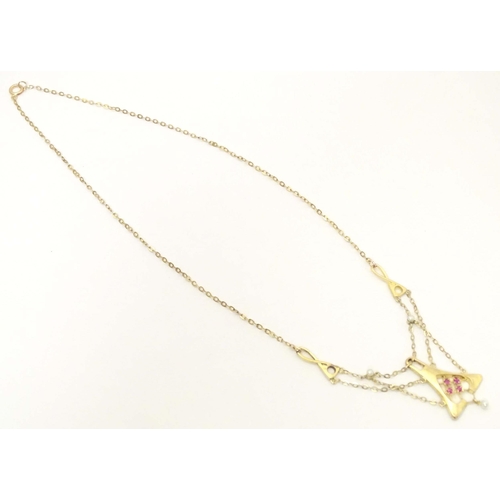 641 - A 14ct gold necklace, the pendant section set with pearls and red stones. The whole approx 19