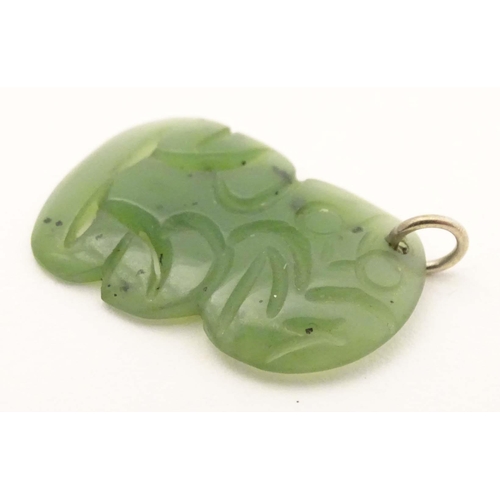 643 - A New Zealand nephrite Maori pendant with carved detail. Approx 1 1/42 long