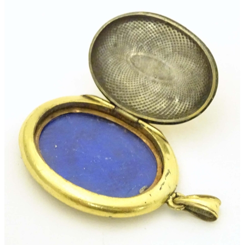 645 - Mourning / memorial jewellery : A yellow metal locket of pendant form with forget-me-not blue and bl... 