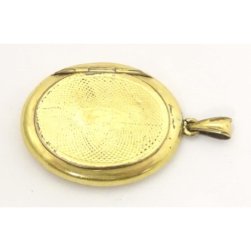 645 - Mourning / memorial jewellery : A yellow metal locket of pendant form with forget-me-not blue and bl... 