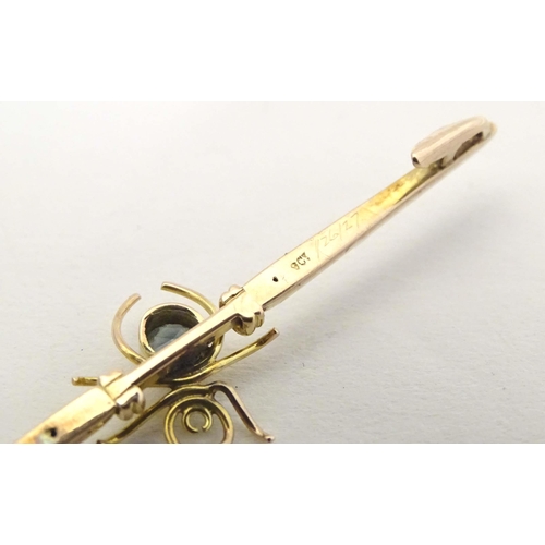 647 - A 9ct gold bar brooch set with spider to centre having a blue stone body 2 1/2