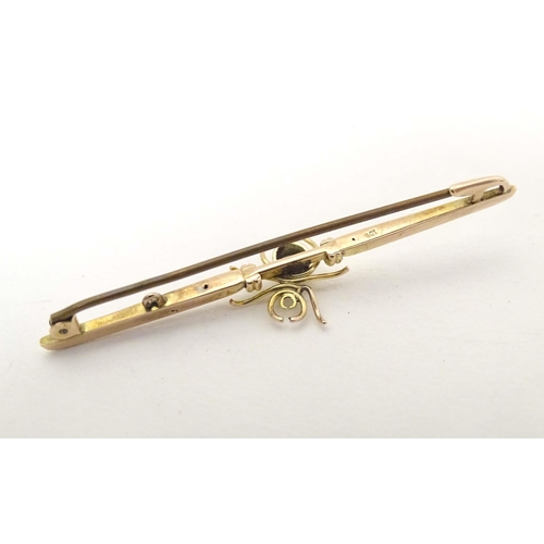 647 - A 9ct gold bar brooch set with spider to centre having a blue stone body 2 1/2