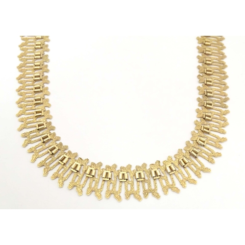 648 - A 9ct gold necklace with textured detail. Hallmarked Birmingham  1975 maker J A Main Ltd. Approx 15 ... 