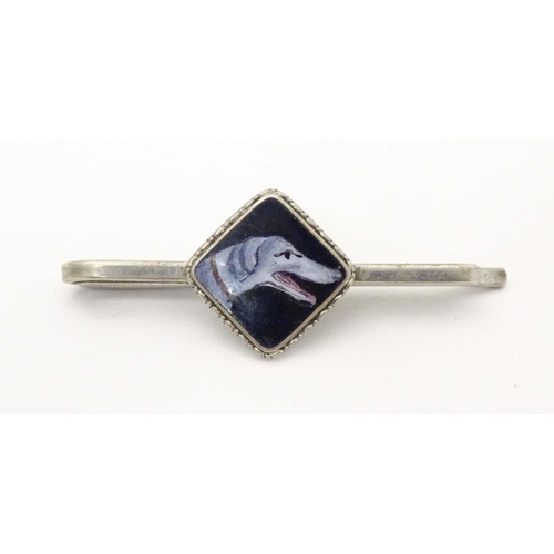 649 - A white metal tie clip with enamel dog head detail to centre. 1 3/4