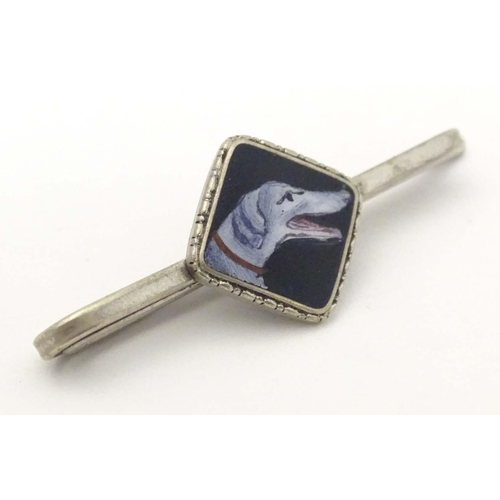 649 - A white metal tie clip with enamel dog head detail to centre. 1 3/4