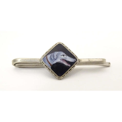 649 - A white metal tie clip with enamel dog head detail to centre. 1 3/4