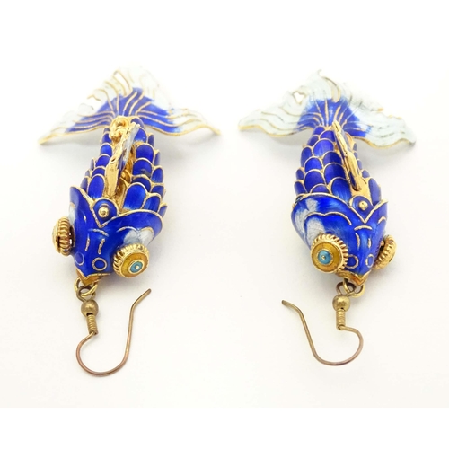 656 - A pair of drop earrings set with enamel and gilt decorated articulated fish. Approx. 3 3/4