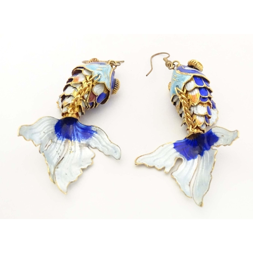 656 - A pair of drop earrings set with enamel and gilt decorated articulated fish. Approx. 3 3/4