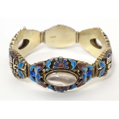 657 - A silver Oriental bracelet with enamel and cabochon detail. Approx. 7