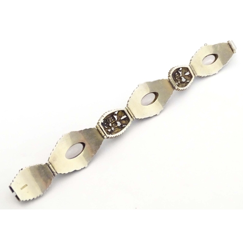 657 - A silver Oriental bracelet with enamel and cabochon detail. Approx. 7