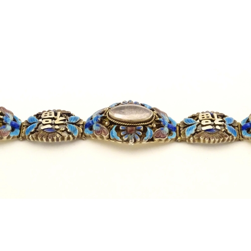 657 - A silver Oriental bracelet with enamel and cabochon detail. Approx. 7