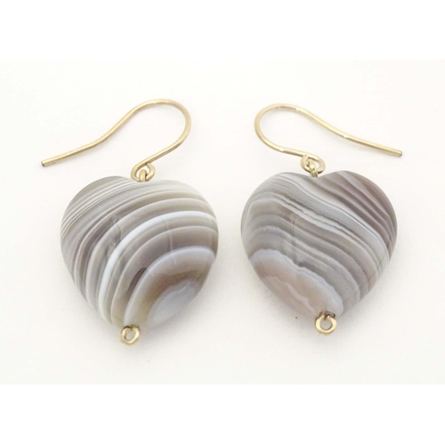 658 - A pair of drop earrings set with banded agate hardstone drop of heart form. Approx. 1 1/2