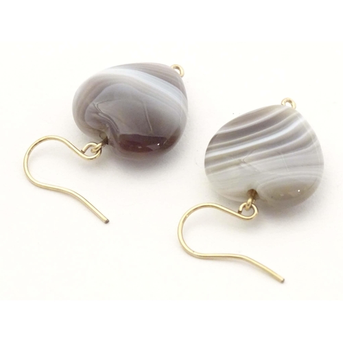 658 - A pair of drop earrings set with banded agate hardstone drop of heart form. Approx. 1 1/2