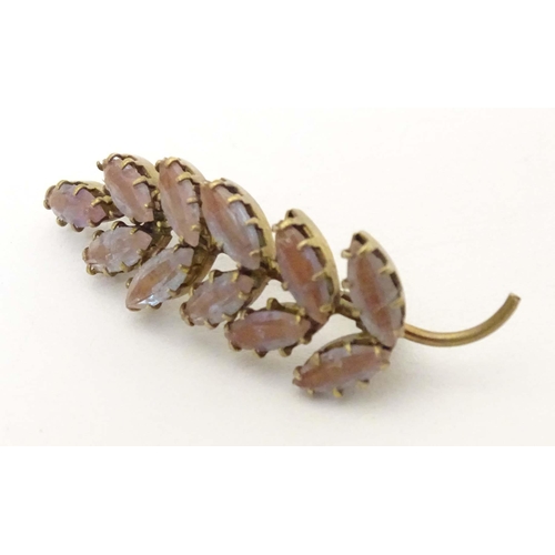 659 - An early 20thC gilt metal brooch of foliate form set with saphiret glass. Approx. 1 3/4