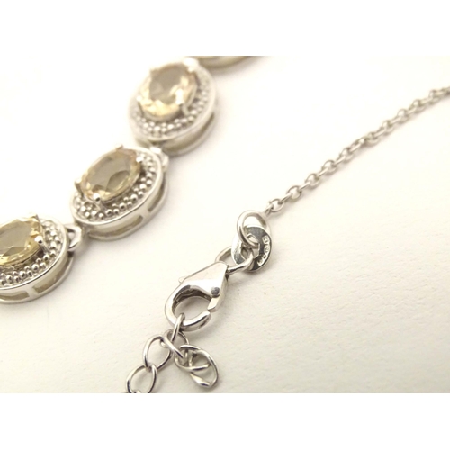 660 - A silver necklace set with 9 facet cut Bolivarian quartz. Approx. 16