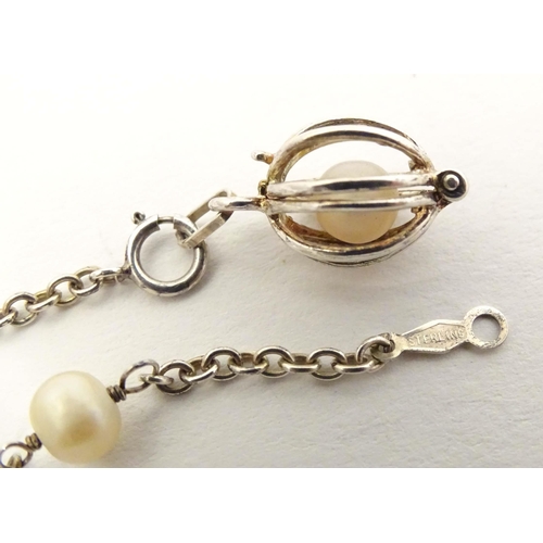 662 - A silver and white metal bracelet set with pearls