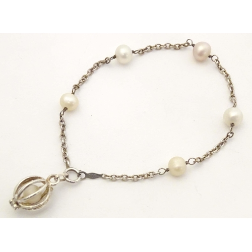 662 - A silver and white metal bracelet set with pearls