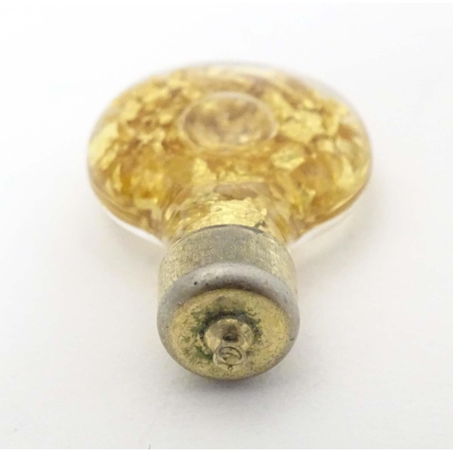 664 - A pendant charm formed as a bottle filled with gilt flecks. Approx. 1