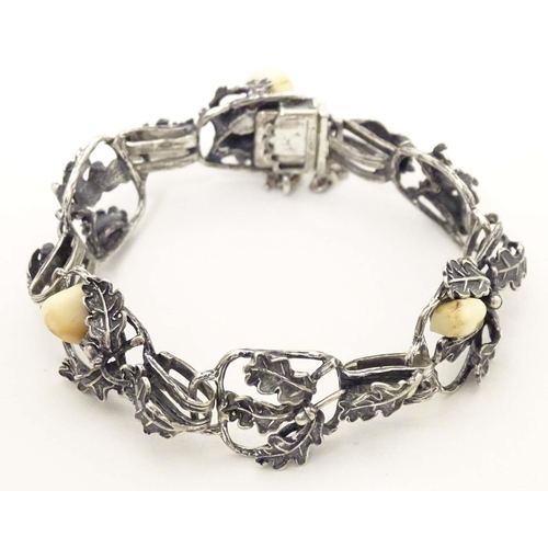 670 - A hunting trophy bracelet set with deer teeth within a white metal .800 silver mounts with oak leaf ... 