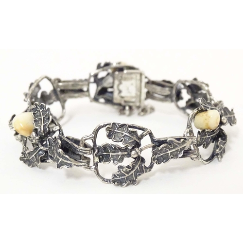 670 - A hunting trophy bracelet set with deer teeth within a white metal .800 silver mounts with oak leaf ... 