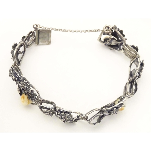 670 - A hunting trophy bracelet set with deer teeth within a white metal .800 silver mounts with oak leaf ... 