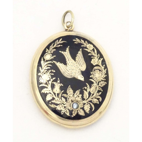 674 - Mourning / memorial jewellery: A Victorian yellow metal pendant locket of oval form with black ename... 