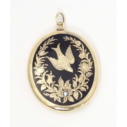 674 - Mourning / memorial jewellery: A Victorian yellow metal pendant locket of oval form with black ename... 