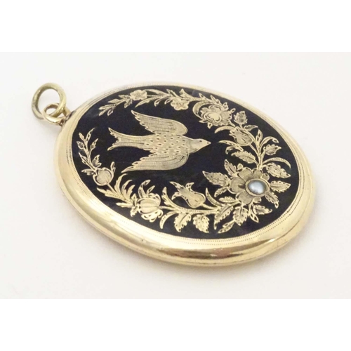 674 - Mourning / memorial jewellery: A Victorian yellow metal pendant locket of oval form with black ename... 