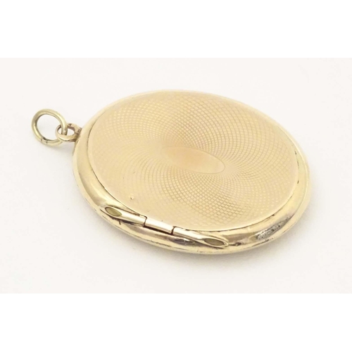 674 - Mourning / memorial jewellery: A Victorian yellow metal pendant locket of oval form with black ename... 