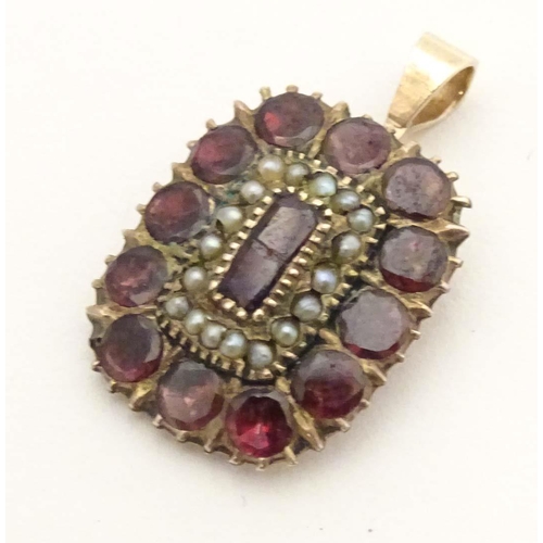 678 - A Victorian yellow metal pendant set with garnets and seed pearls, engraved Charlotte Hill to revers... 