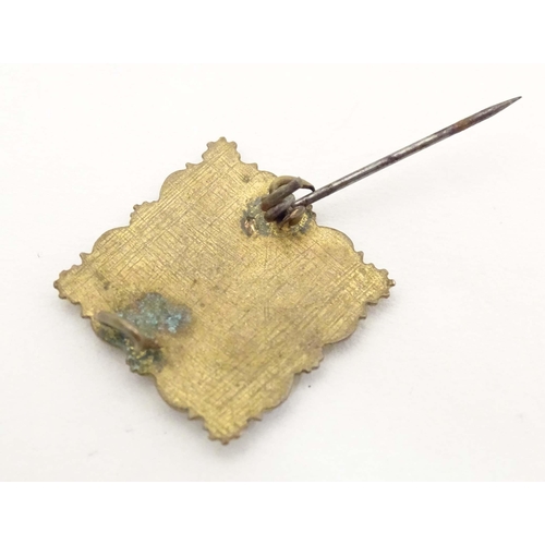 682 - A gilt metal brooch of square form with enamel floral decoration and titled Messines. Approx. 1