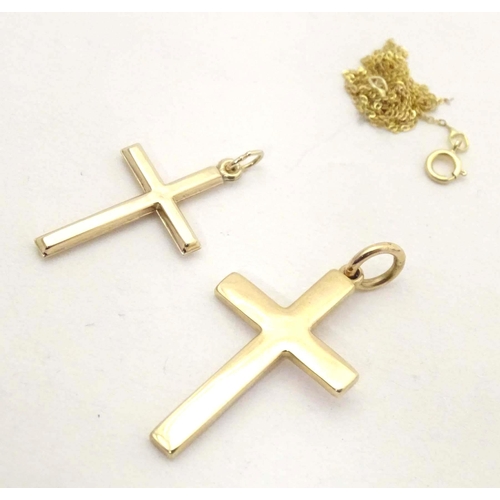 685 - A 9ct gold pendant of cross form with a 9ct gold chain, together with a yellow metal pendant of cros... 