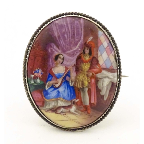 686 - An oval brooch with enamel scene to centre depicting a couple with their dog, within a white metal m... 