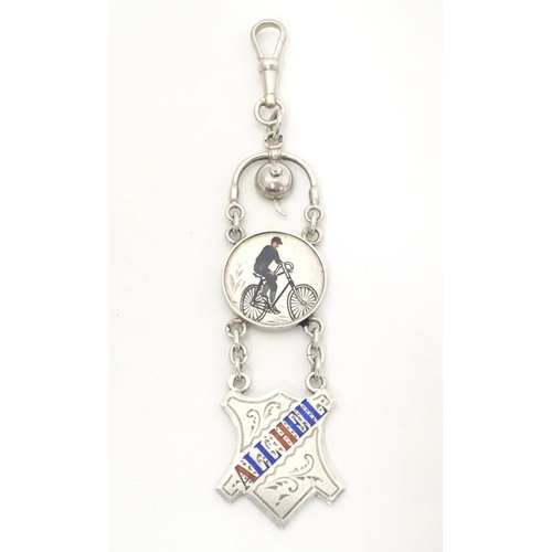 687 - Cycling interest: An early 20thC pendant fob with enamel decoration depicting a man on a bicycle, su... 