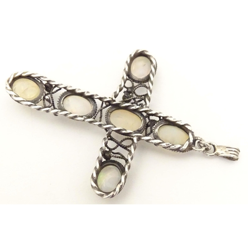 691 - An Arts & Crafts style white metal pendant of cross form set with six water opal style cabochon. App... 