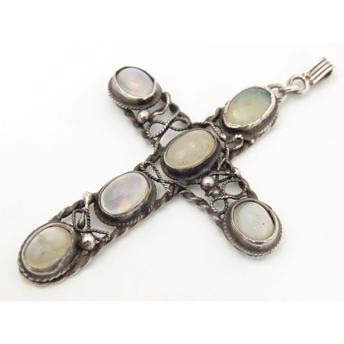 691 - An Arts & Crafts style white metal pendant of cross form set with six water opal style cabochon. App... 