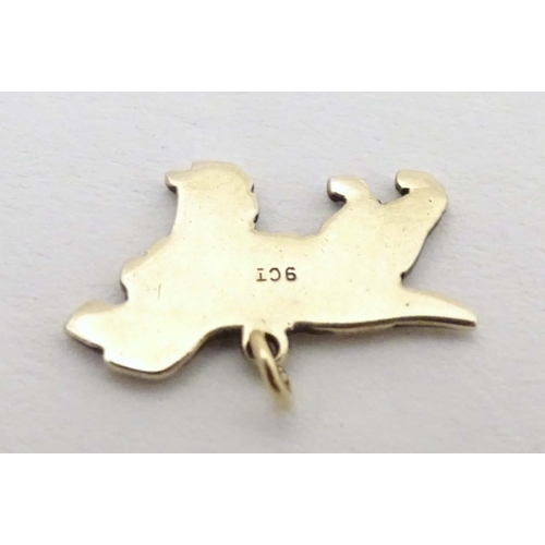 692 - A 9ct gold pendant charm formed as a spaniel dog with enamel detail. Approx. 3/4