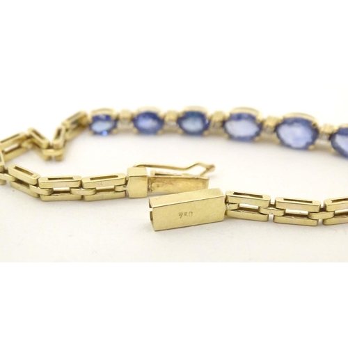 693 - An 18ct gold bracelet set with 9 facet cut topaz and 8 diamonds. Approx. 7