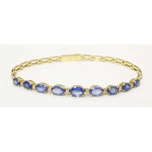 693 - An 18ct gold bracelet set with 9 facet cut topaz and 8 diamonds. Approx. 7