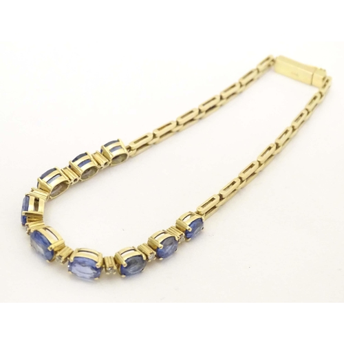 693 - An 18ct gold bracelet set with 9 facet cut topaz and 8 diamonds. Approx. 7