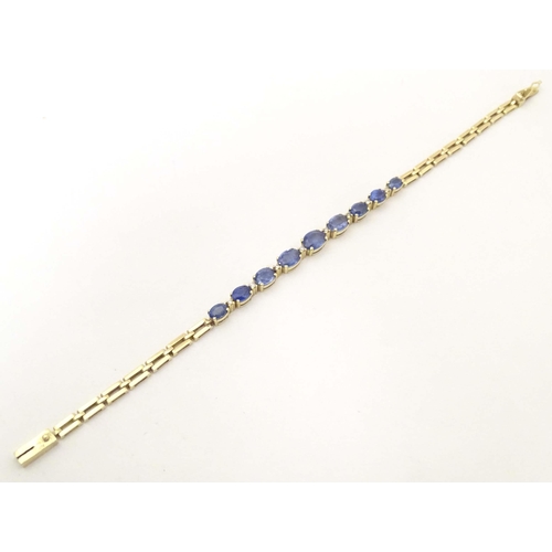 693 - An 18ct gold bracelet set with 9 facet cut topaz and 8 diamonds. Approx. 7