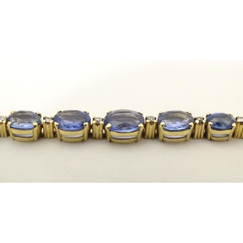 693 - An 18ct gold bracelet set with 9 facet cut topaz and 8 diamonds. Approx. 7