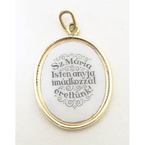 694 - A Continental gold pendant with enamel decoration depicting Madonna and Child with Hungarian script ... 