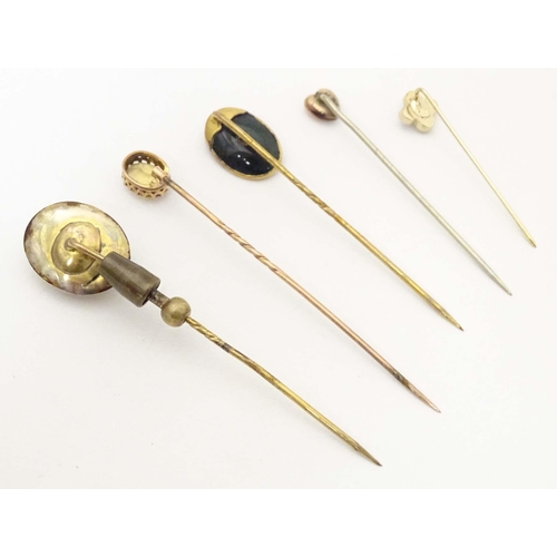 699 - Five assorted 19thC and later stick pins to include one set with bloodstone and central garnet, anot... 