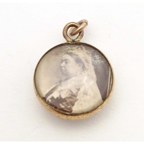 703 - A Victorian double sided pendant set with images of Queen Victoria. Approx. 3/4