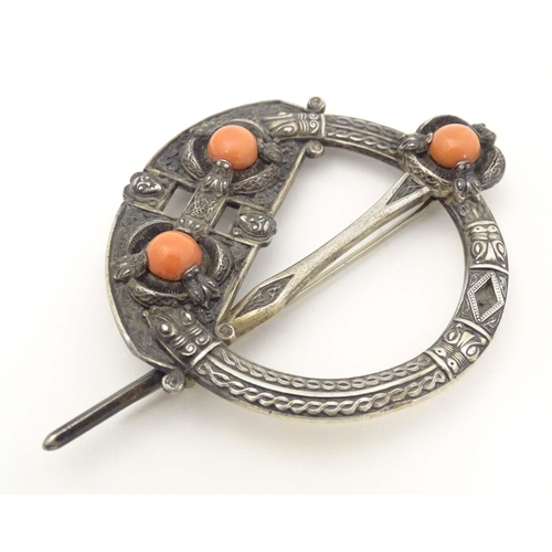 704A - A Victorian Irish / Celtic white metal tara brooch set with three coral cabochon. Marked West & Son,... 